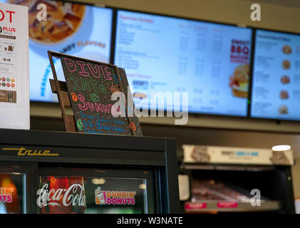 Cromwell, CT USA. Jul 2019. A welcoming sign for the summer fun ahead at a local Dunkin` Donuts. Illustrative editorial. Stock Photo